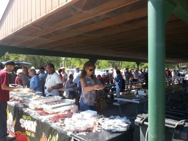 August 2016 Picnic — food line under pavilion with Famous Daves Smokin banner