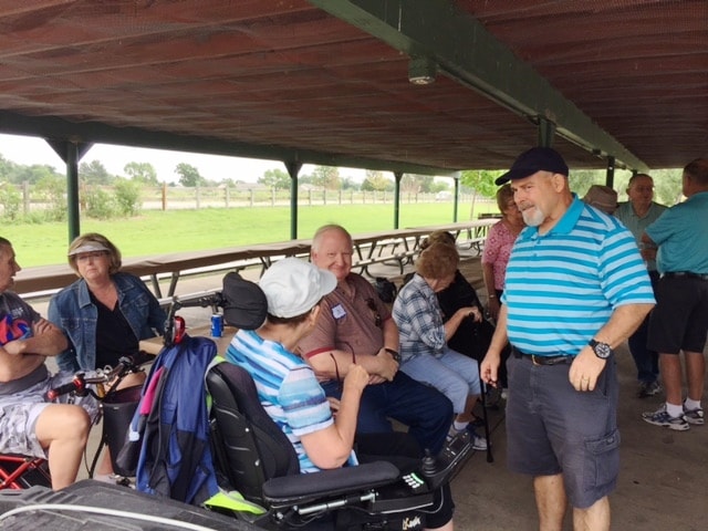 August 2017 Picnic — attendees gathered under pavilion with wheelchair