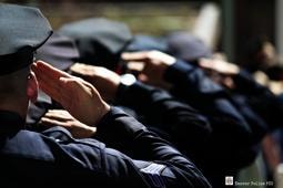 Officers saluting in formation