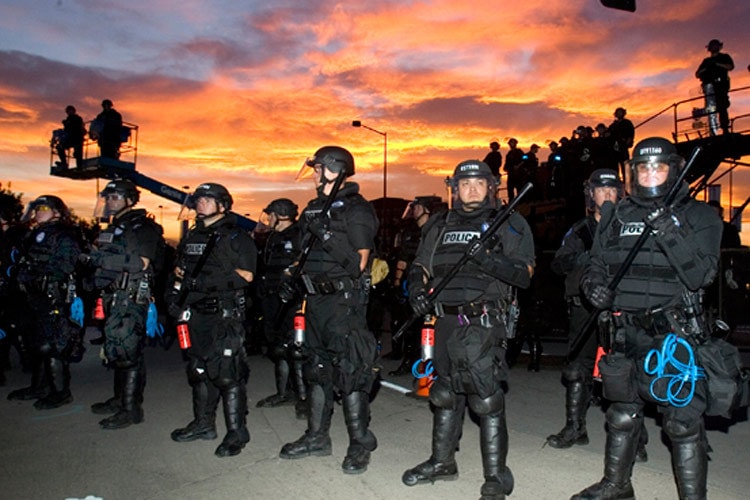 Police officers in tactical gear at sunset